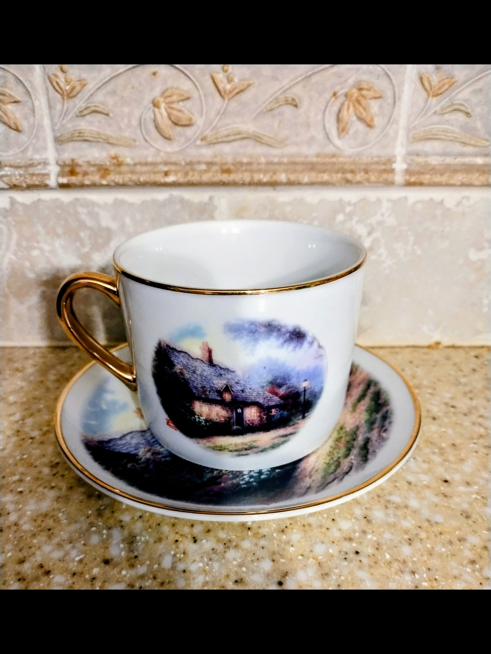 Thomas Kinkade "Moonlight Cottage" Gold-Trimmed Cottage Teacup and Saucer Set.